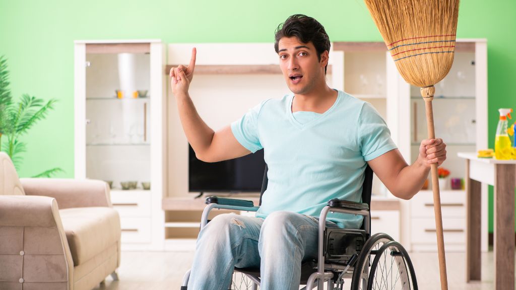 man on wheelchair cleaning the house